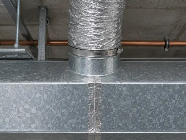 A sheet-metal duct trunk with a flexible branch connected to it